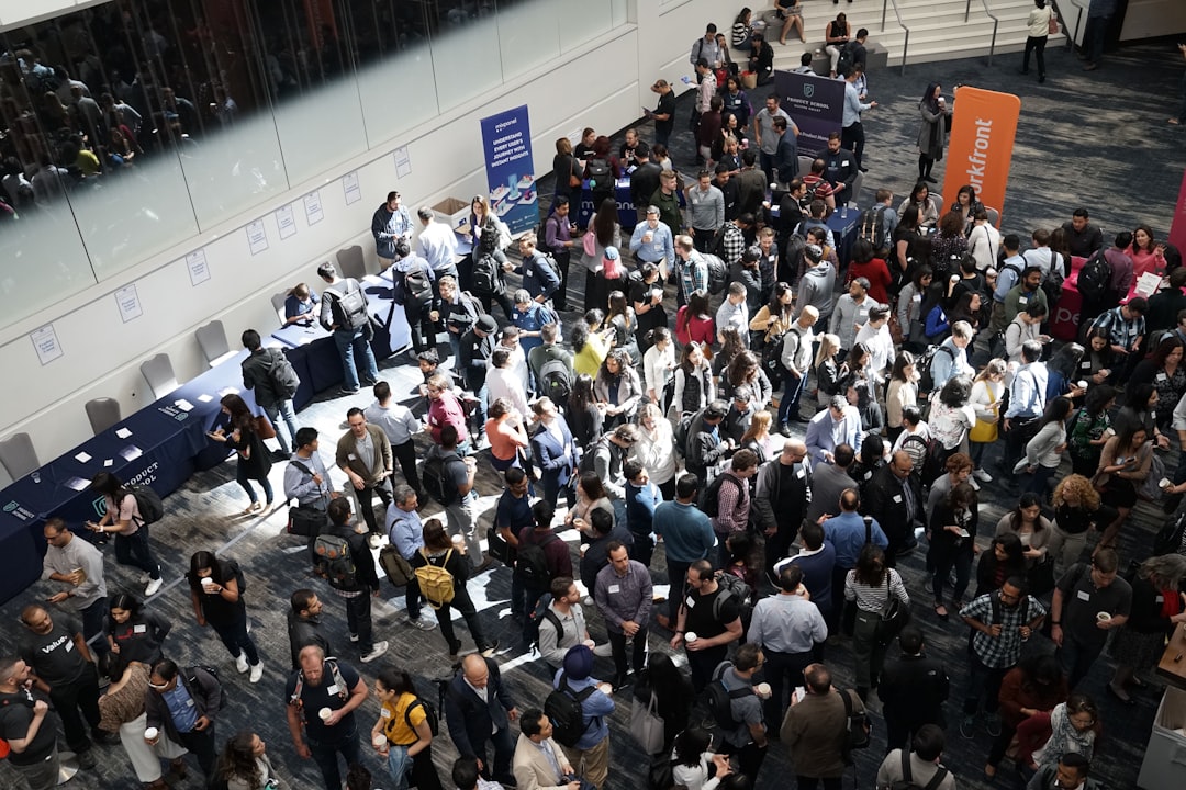 Crowd of people gathered in a convention hall lobby at a career fair