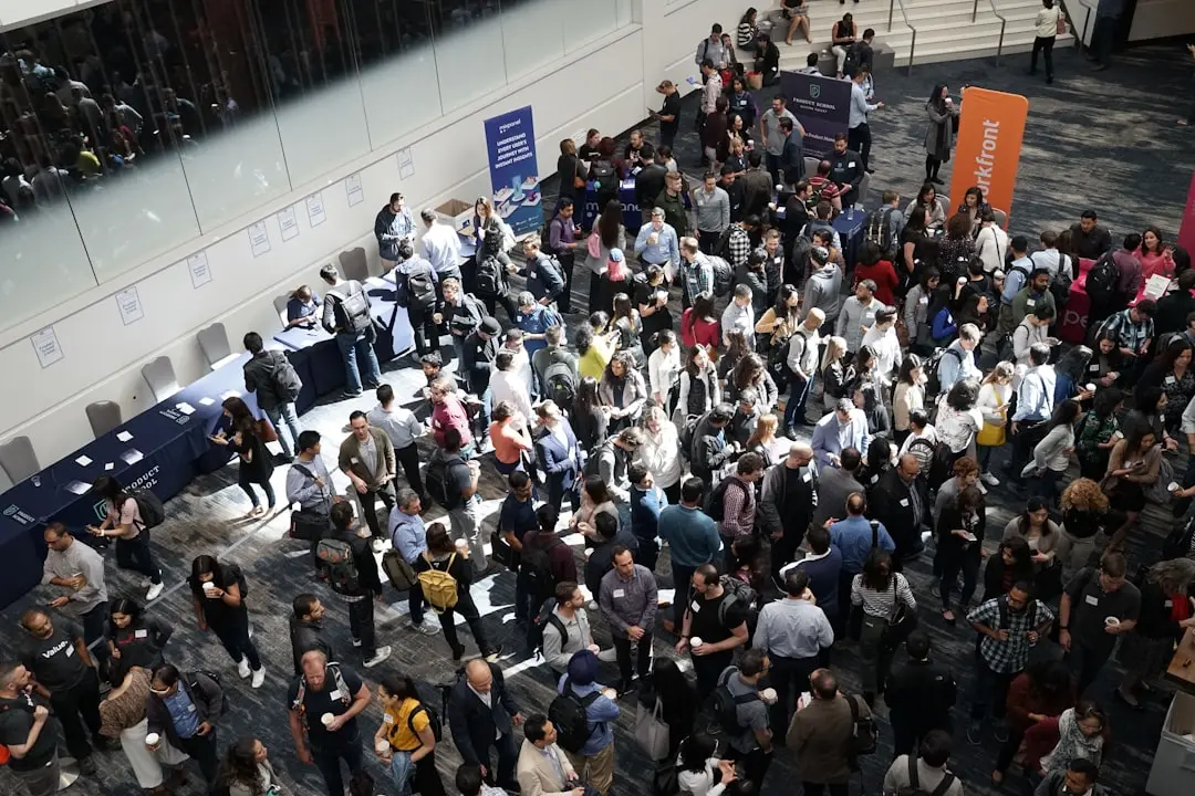 Crowd of people gathered in a convention hall lobby at a career fair