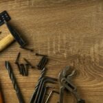 A set of hand tools on a wooden workbench, representing where to find home repair help for small jobs
