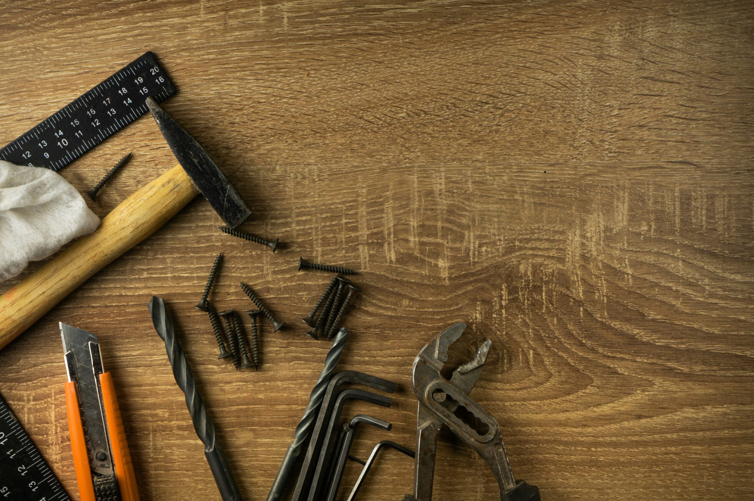 A set of hand tools on a wooden workbench, representing where to find home repair help for small jobs
