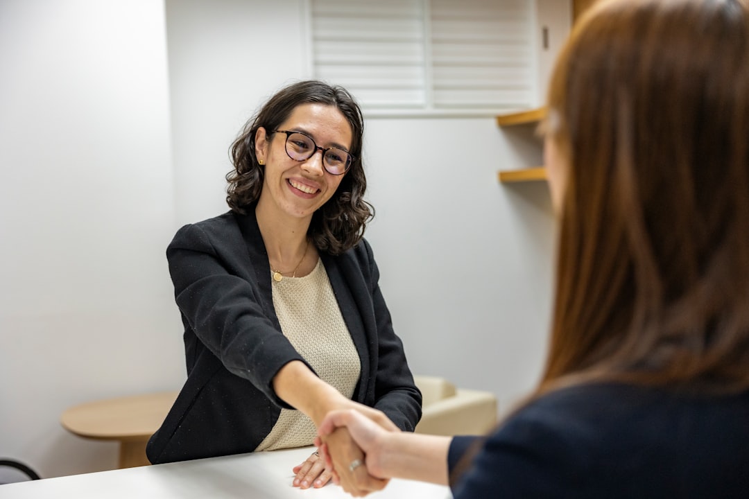 Job seeker shaking hands with a recruiter after a conversation, illustrating Vancouver job fair tips for following up afterward