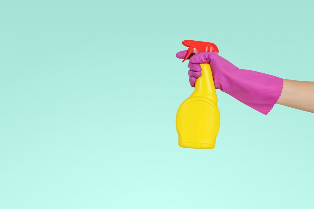 Person spraying a cleaning solution while doing cleaning jobs in Calgary